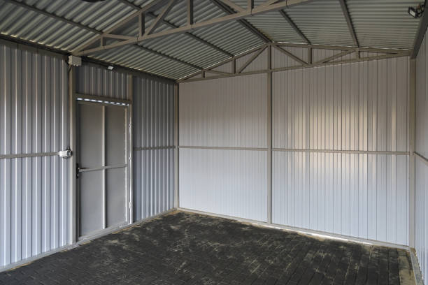 istock Interior of new empty iron garage, textured surface road tile on the ground, door in wall 2051490198