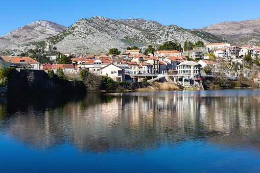 Trebinje city. Balkan houses in city center with red roofs and mountains at background. Old city Trebinje, Bosnia and Herzegovina