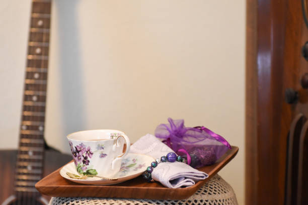 An Elegant cup of tea and a sweet treat sit ready to be enjoyed.