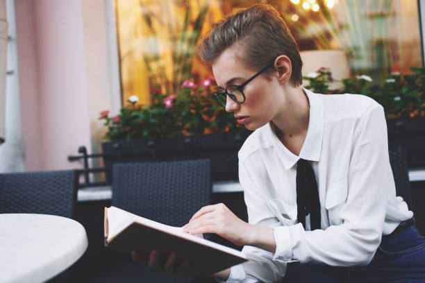 istock short haired woman with a book in his hands reading education 2051509141