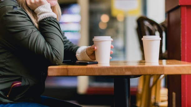 Unrecognizable Person Holding Coffee Cup in Coffee Shop