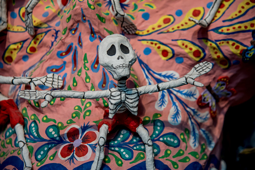 Handcrafted clay figurines of Catrinas, a traditional symbol of Dia de los Muertos, showcasing intricate details and vibrant colors.