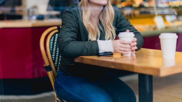 istock Unrecognizable Person Holding Coffee Cup in Coffee Shop 2051544785