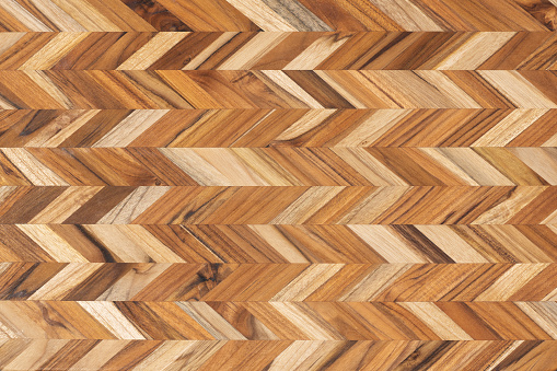 Top view of a textured, brown, chevron patterned cutting board.