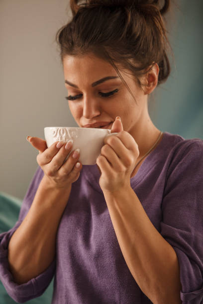 istock Young woman sipping herbal tea 2051649145