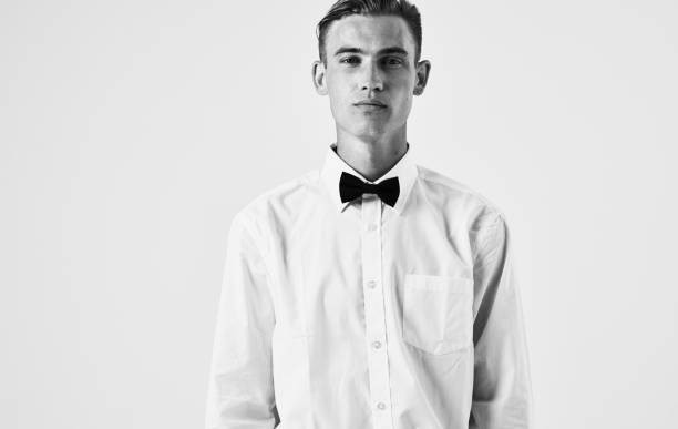istock handsome guy in shirt and bow tie on light background portrait 2051671120