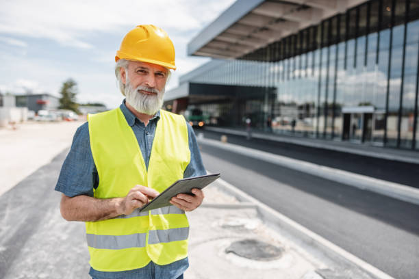 istock Cheerful Mature Caucasian Male Employee Working In A Construction Site 2051671141