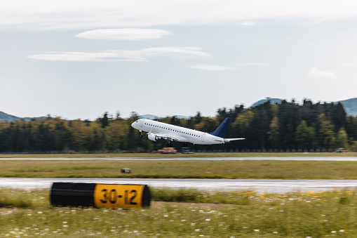 Commercial airplane taking off from an airports runway.