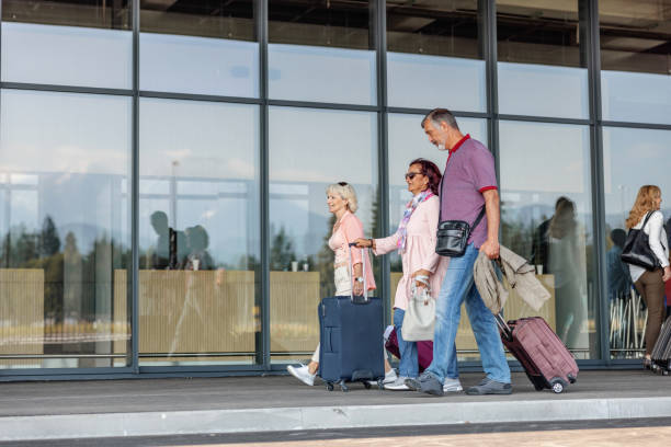 istock Three Multicultural Passengers Getting Ready To Enter The Airport 2051672743