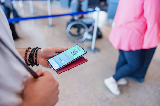 istock Caucasian Man Holding Online Boarding Pass In His Cellphone 2051673256