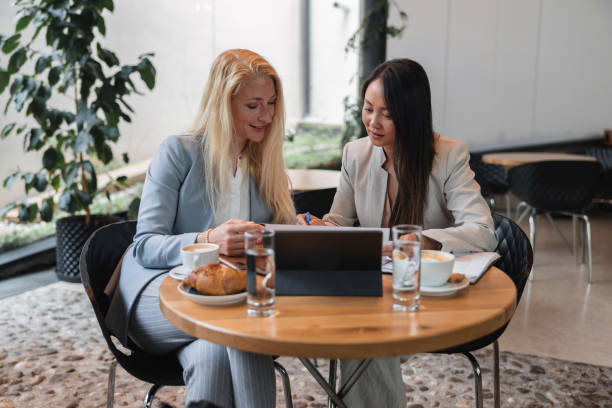 istock Diverse Female Work Colleagues Working At A Coffee Shop 2051678073