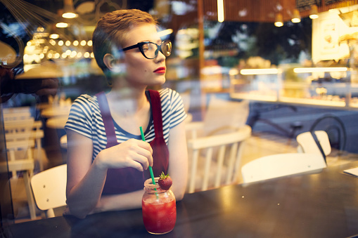 woman sitting in cafe cocktail vacation pensive look lifestyle. High quality photo