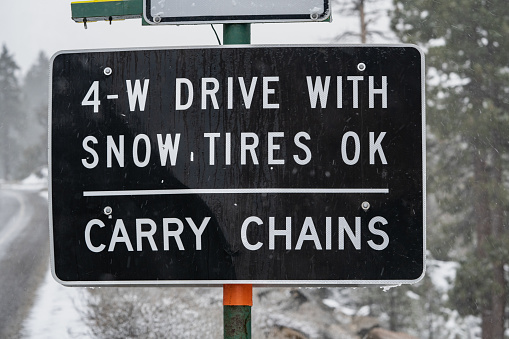 Highway sign in Sierra Nevada mountains that reads,