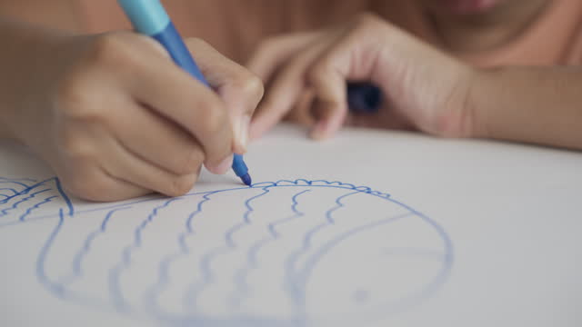 A girl drawing with colored pen