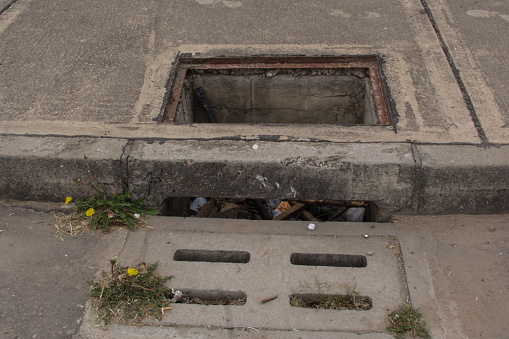 danger Broken manhole cover on street dangerous place in the city