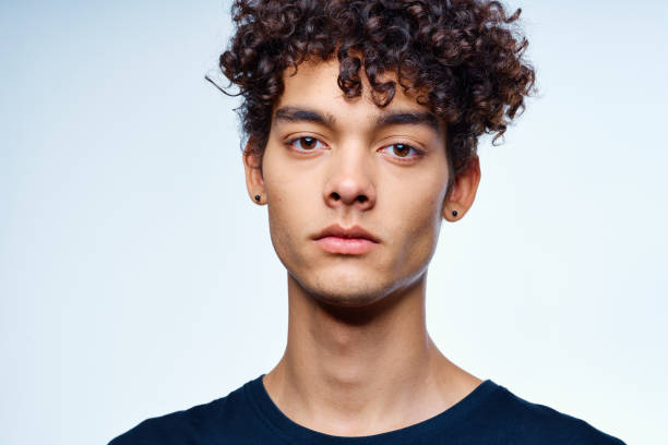 istock cute guy with curly hair cropped view isolated background studio 2051742709
