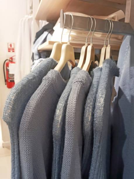 istock gray sweaters hanging on a hanger in a supermarket 2051786079