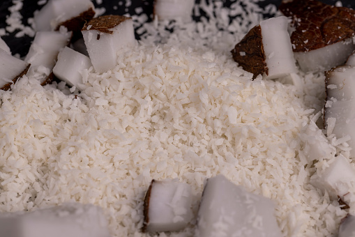 white coconut pulp and dried coconut flakes, a close-up of which is used in the preparation of desserts