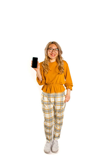 an Asian woman showcases her excitement as she interacts with her cell phone, capturing the essence of modern connectivity against a clean white backdrop.