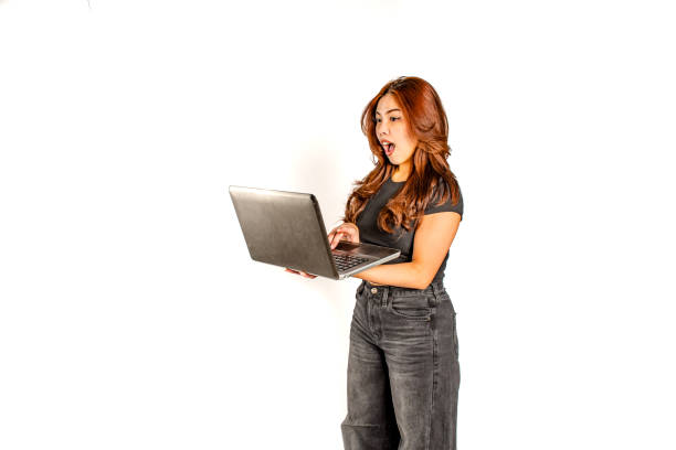Beautiful Young Woman Using Laptop In Living Room