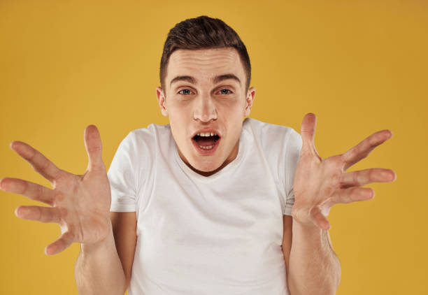 istock happy brunette man on yellow background shows positive hand gesture 2051822366