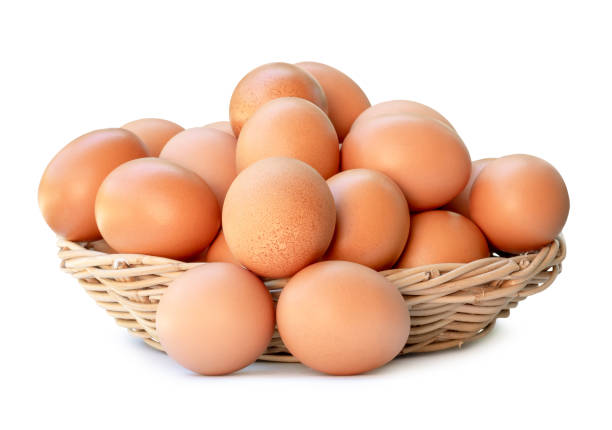 istock Front view of fresh brown chicken eggs in stack in woven bamboo basket isolated on white background with clipping path 2051884895