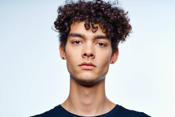 istock cute guy with curly hair cropped view isolated background studio 2051925629