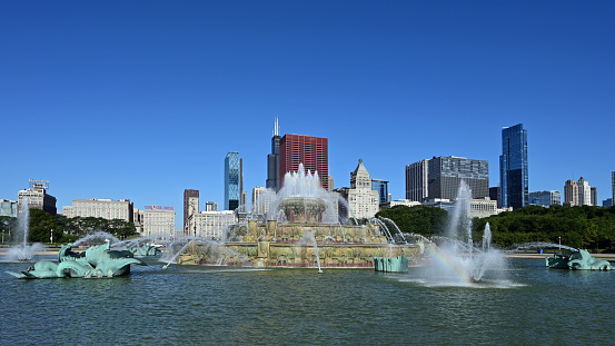 Chicago, Illinois - August 9, 2019: Buckingham Fountain and Chicago skyline from Grant Park on clear sunny summer morning.