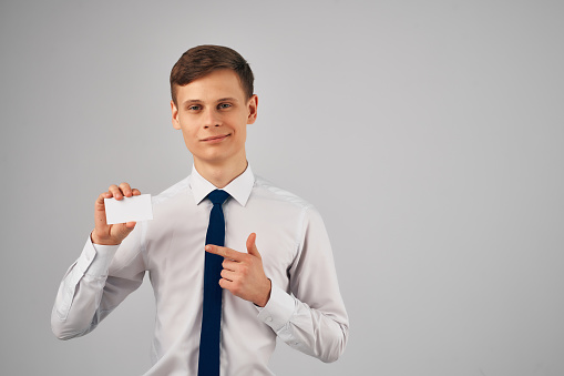 business man in shirt with tie office work business card in hand. High quality photo