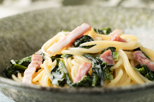 Rich and delicious spaghetti with spinach and bacon tossed in cream sauce