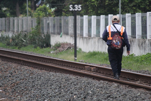 Yogyakarta, Indonesia, December 10, 2023; Indonesian railway engineers check the railroad tracks on a sunny morning.