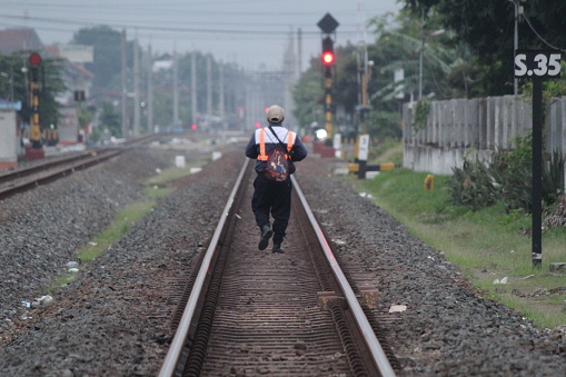 Yogyakarta, Indonesia, December 10, 2023; Indonesian railway engineers check the railroad tracks on a sunny morning.