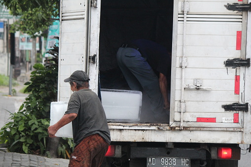 Yogyakarta, Indonesia, 10 December 2023; Indonesian expedition worker unloading cargo