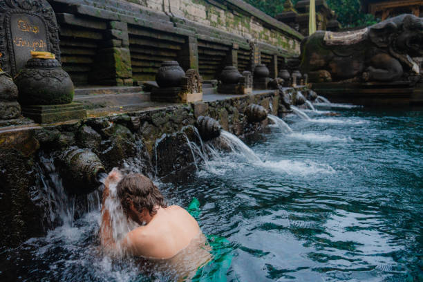 istock Man doing purifying ritual in Tirta empul holy spring, Ubud 2052081728