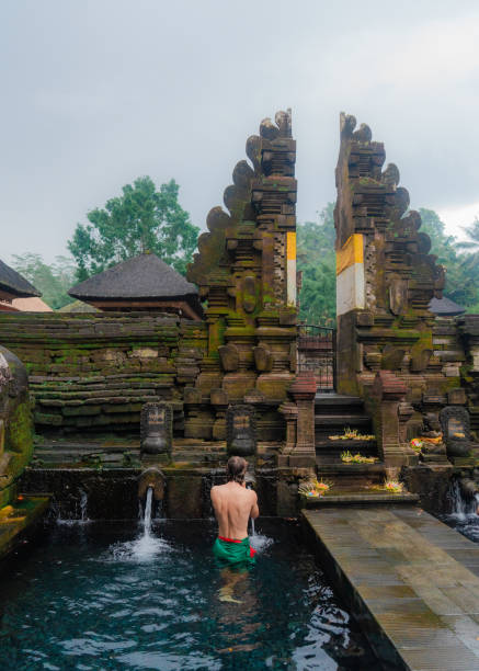 istock Man doing purifying ritual in Tirta empul holy spring, Ubud 2052081732