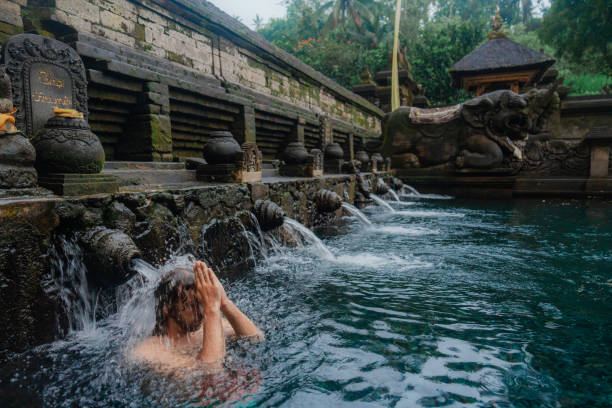 istock Man doing purifying ritual in Tirta empul holy spring, Ubud 2052083318