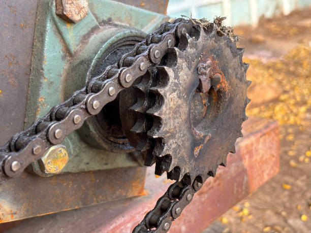 istock Close-up of a rusty industrial chain and sprocket, with blurred background 2052083836