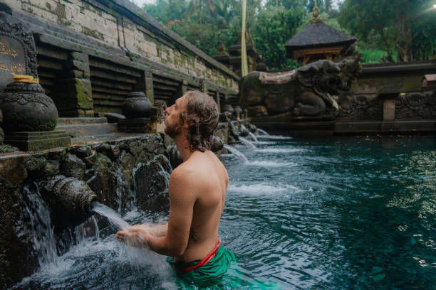 istock Man doing purifying ritual in Tirta empul holy spring, Ubud 2052086906