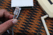 Selective focus to RJ45 Connector with crimping RJ45 tool on blurry background