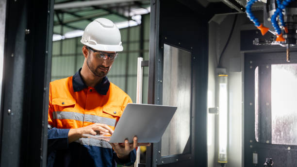 istock Hispanic technician showcasing mastery in configuring a cutting-edge CNC milling machine for precision manufacturing. 2052125911
