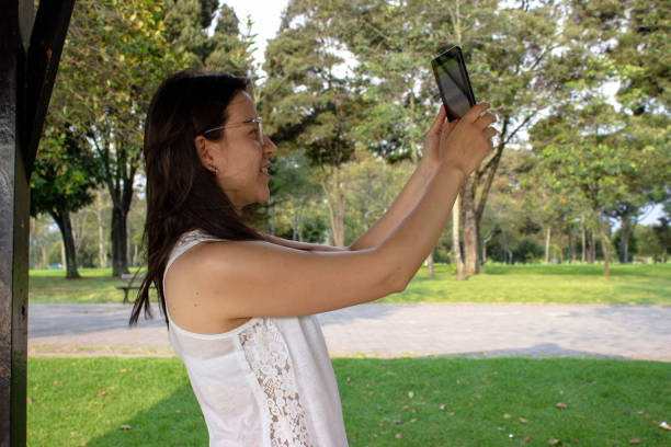 istock Beautiful young woman doing remote work outside 2052155273