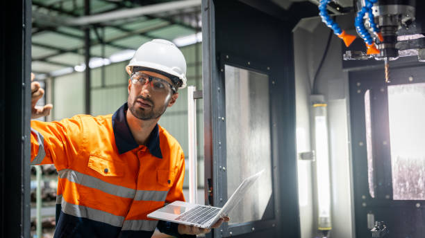 istock Hispanic technician showcasing mastery in configuring a cutting-edge CNC milling machine for precision manufacturing. 2052184530