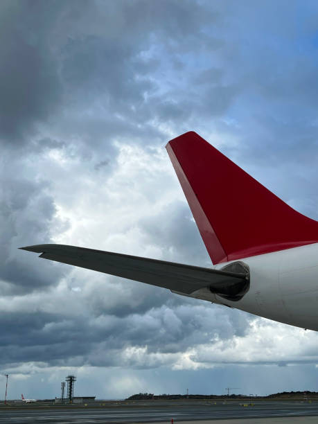 istock airplane wing is foreground cloudy weather is background vertical aerospace industry still 2052195355