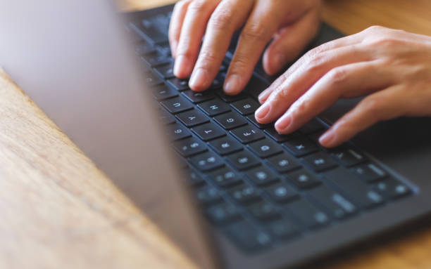 istock Closeup image of a woman working and typing on laptop computer keyboard 2052195707