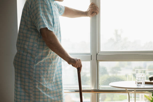 istock Old sick man standing leaning on his cane 2052209006