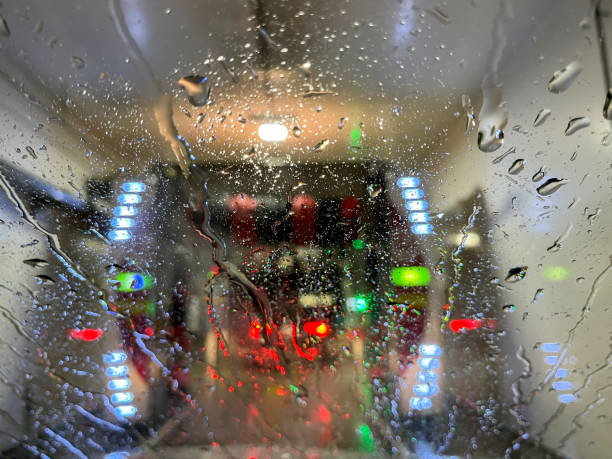 This image shows an abstract texture background of rinse water on the windshield of a vehicle in an automated car wash.