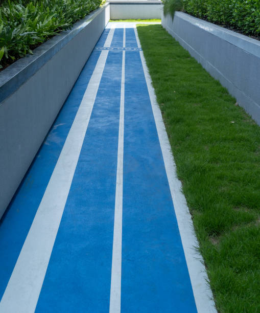 istock Outdoor Blue Running Track with Green Lawn 2052250716