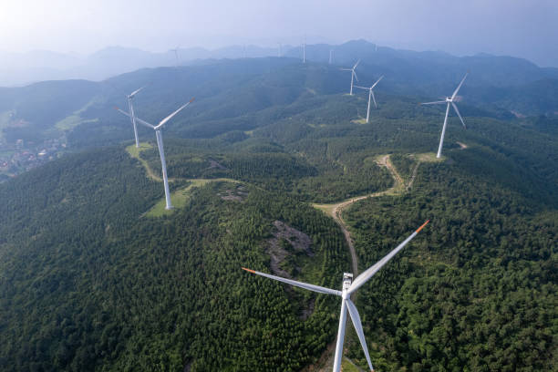 istock Cloudy and foggy mountains and wind turbine clusters 2052272562