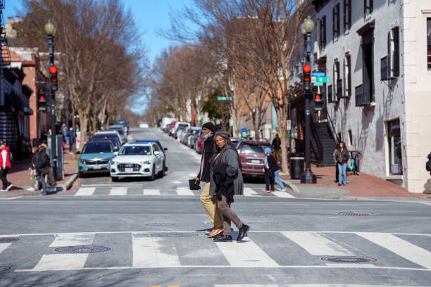 Active senior couple crossing the street while exploring Washington DC in the winter