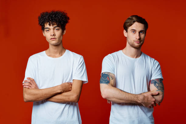 istock two friends in white t-shirts stand side by side isolated background communication 2052322461